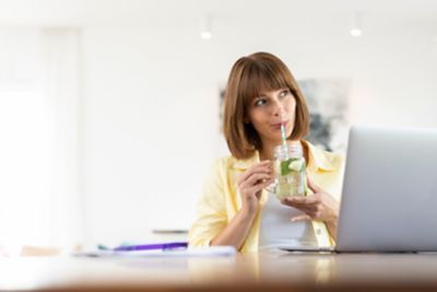 Girl Drinking from Paper Straw